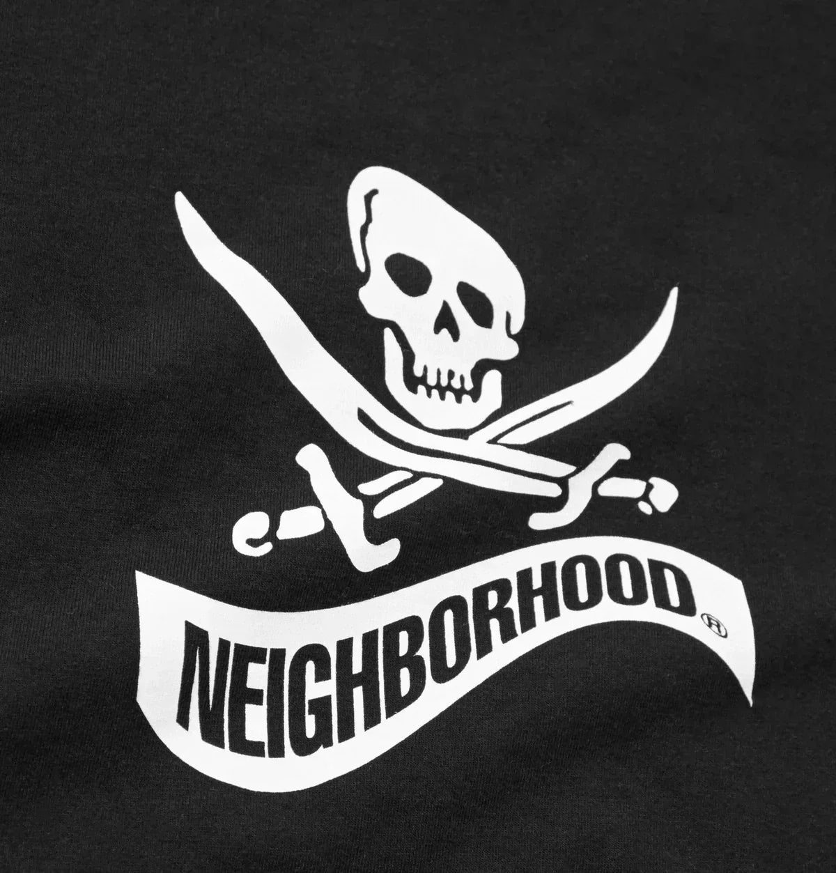 Black neighborhood t-shirt with white skull and crossed swords logo and brand name printed below in the neighborhood nbhd collection
