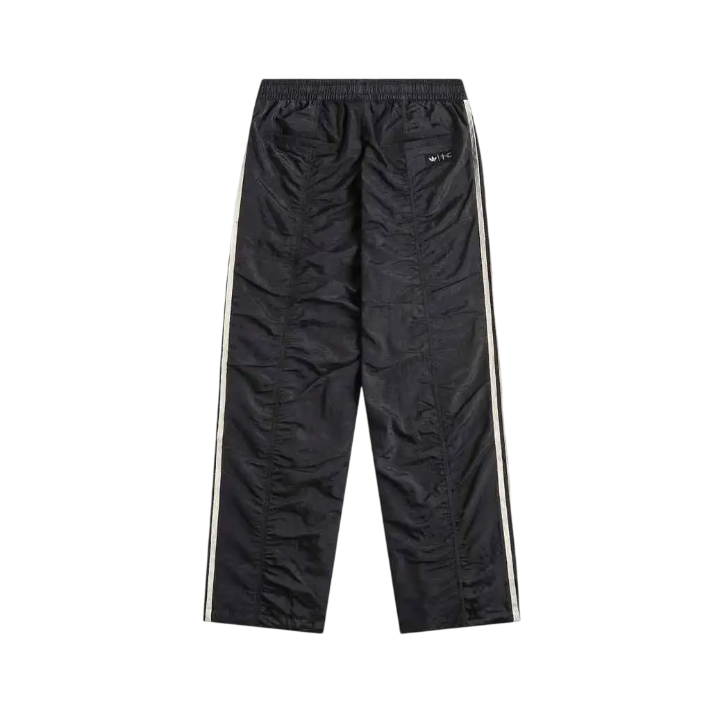 Adidas x Thug Club teamgeist black athletic sweatpants with white side stripes and logo on the thigh