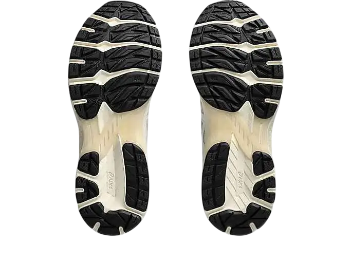 Black and cream-colored asics gel-terrain white lake grey running shoe soles with textured grippy tread pattern