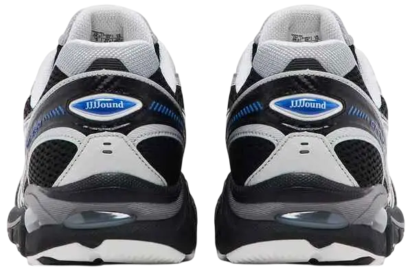 Black and white nike air max 270 sneakers with blue accents and visible air unit in the heel viewed from the back