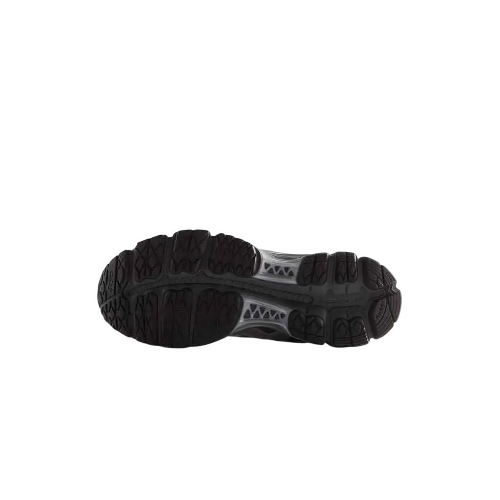 Black rubber sole with textured tread and translucent midsole of asics x kith gel-kayano 12.1 tornado pure silver