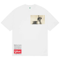 White cotton b.Eautiful Guriko T-shirt featuring a vintage black and white photo of a man playing drum with Glico logo
