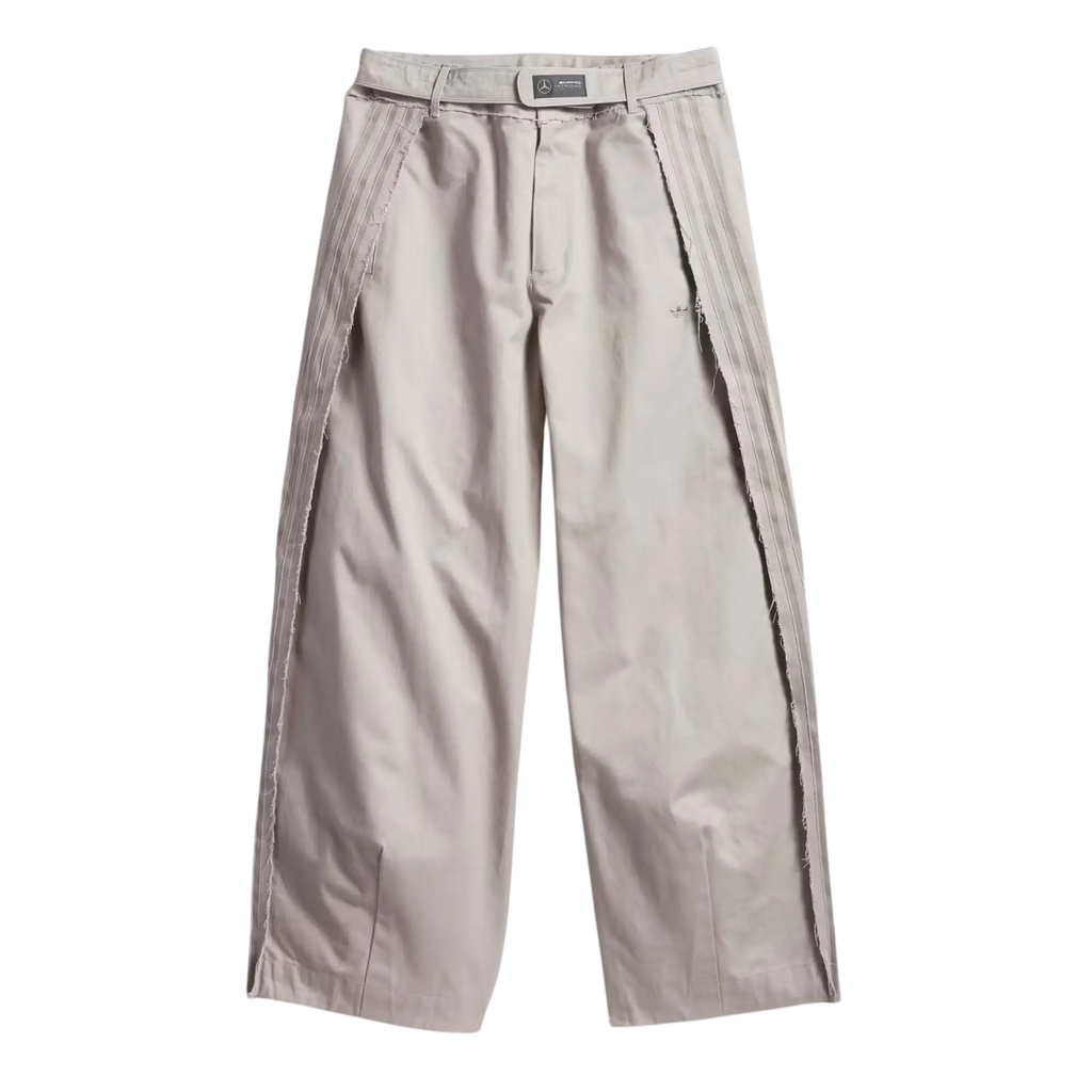 Beige bad bunny x mercedes amg race pants with pleats and vertical seam detailing on outer legs in clear granite color