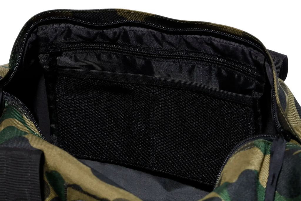 Bape x Outdoor Products green camo duffel bag with black interior lining and mesh pocket for organized storage