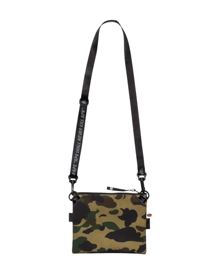 Bape x outdoor products camo mini shoulder bag green with camouflage pattern and black strap featuring white text