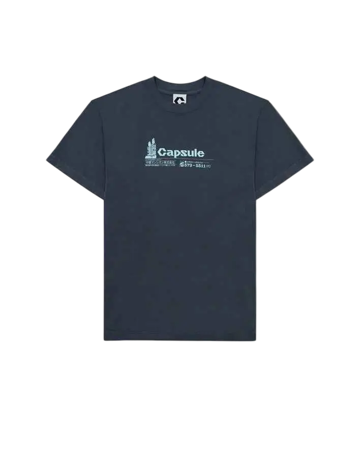 Dark gray short-sleeved Capsule Nagakin t-shirt with white capsule logo and graphic printed on the chest