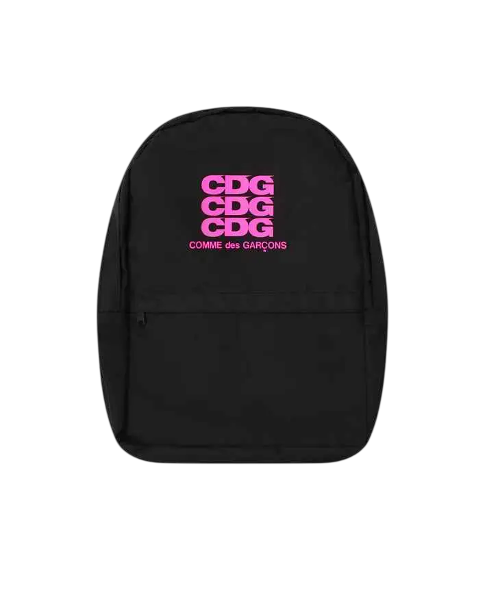 Black comme des garcons backpack with bold pink cdg logo stacked vertically and brand name beneath