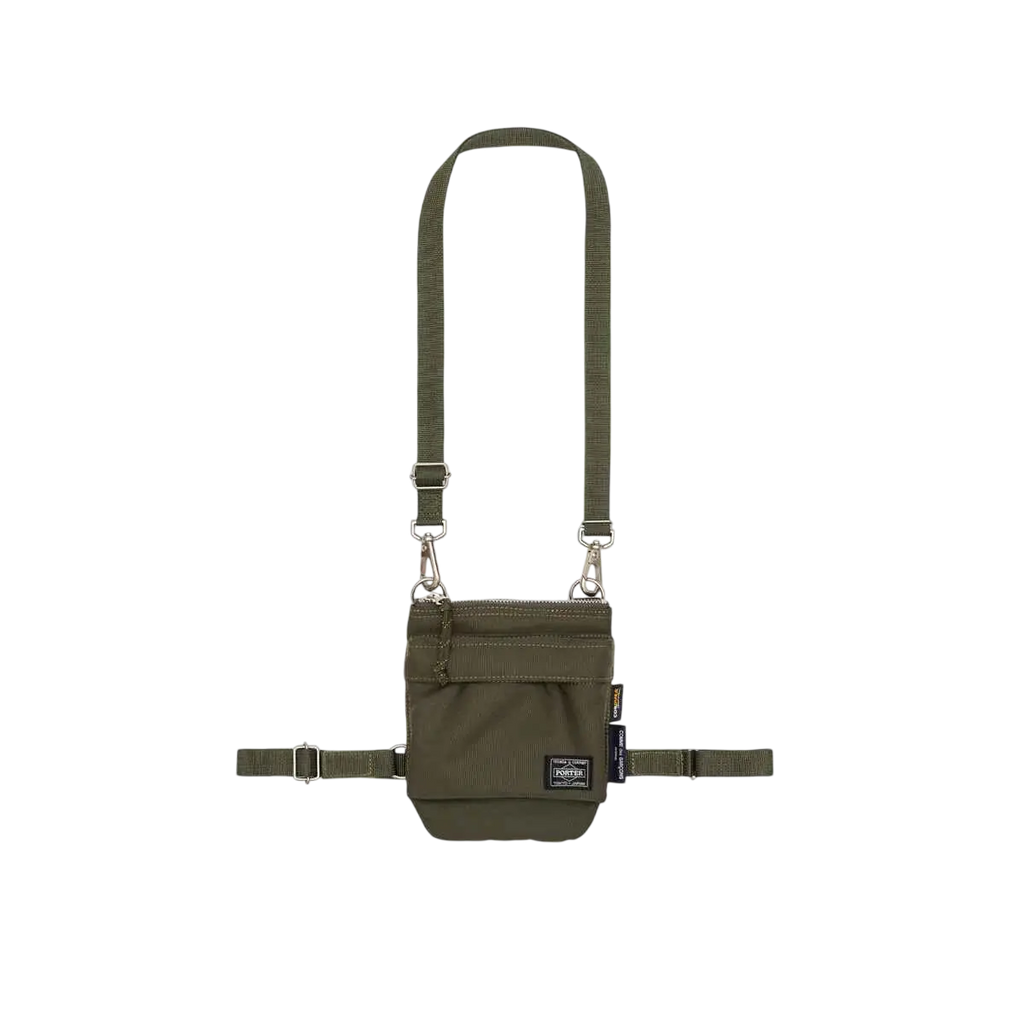 Olive green tactical crossbody bag with adjustable straps and front zippered pocket comme des garcons x porter khaki