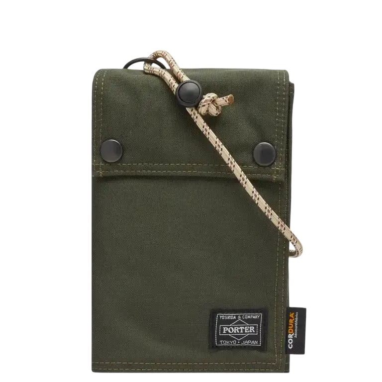 Olive green canvas porter wallet with black button closures and beige patterned cord strap from comme des garcons x porter