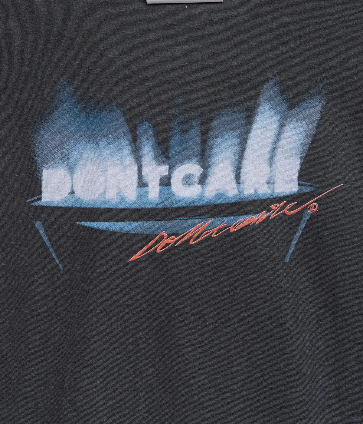 Black cotton t-shirt featuring bold white dontcare text above blue flames with an orange cursive signature below