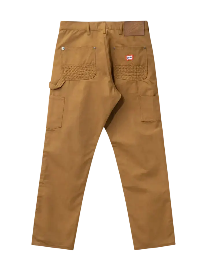 Back view of tan ice cream work pants in brown canvas with textured patch pockets and small red logo on back right pocket