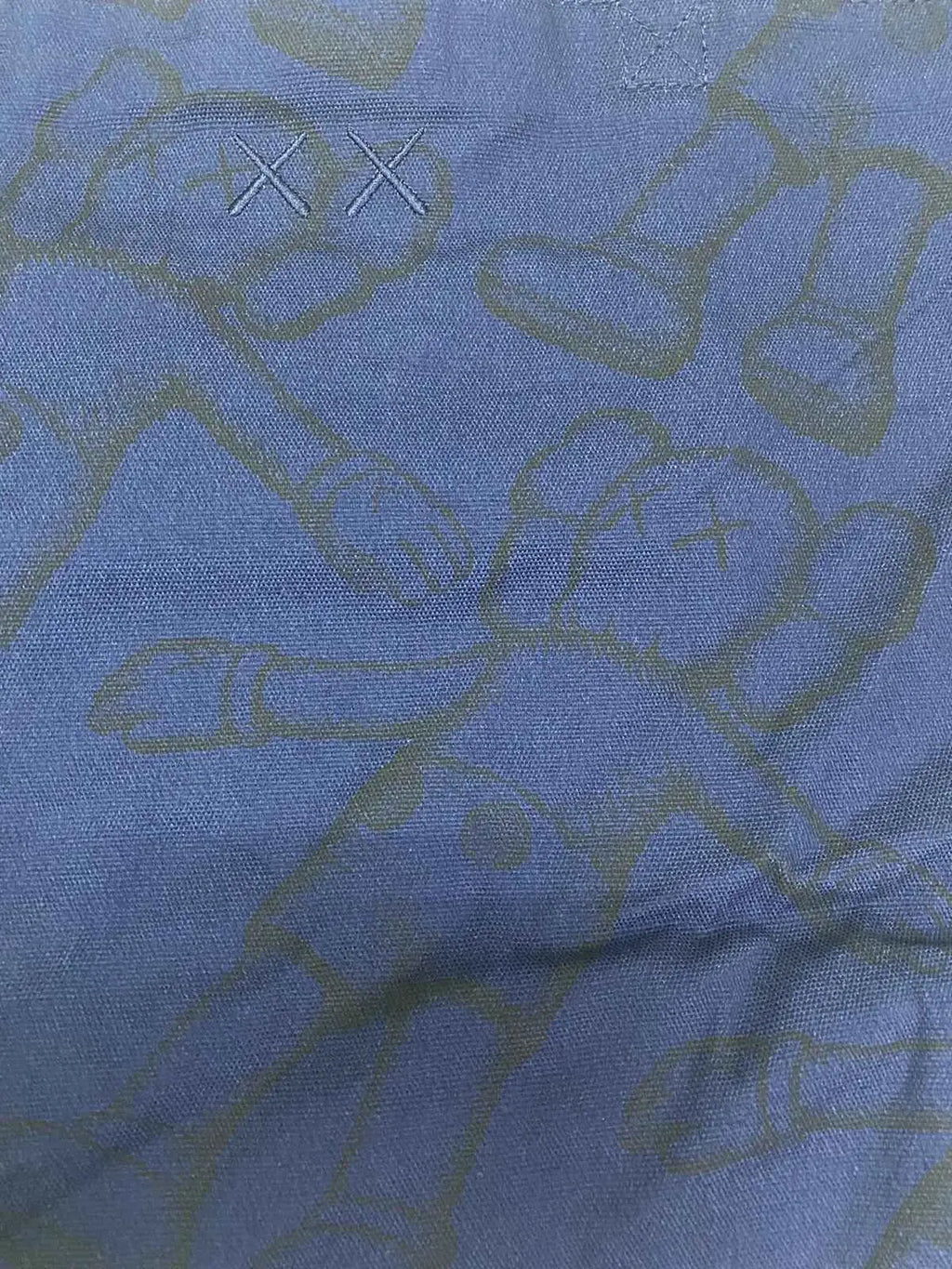 Blue denim Kaws x Uniqlo allover print tote navy with subtle greenish yellow abstract pattern and embroidered xx logo