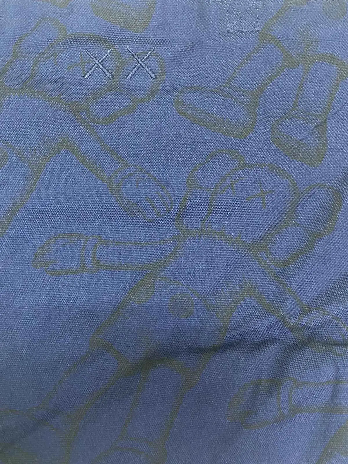 Blue denim Kaws x Uniqlo allover print tote navy with subtle greenish yellow abstract pattern and embroidered xx logo
