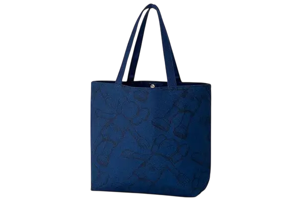 Deep blue Kaws x Uniqlo allover print tote bag with subtle embroidered pattern and sturdy handles