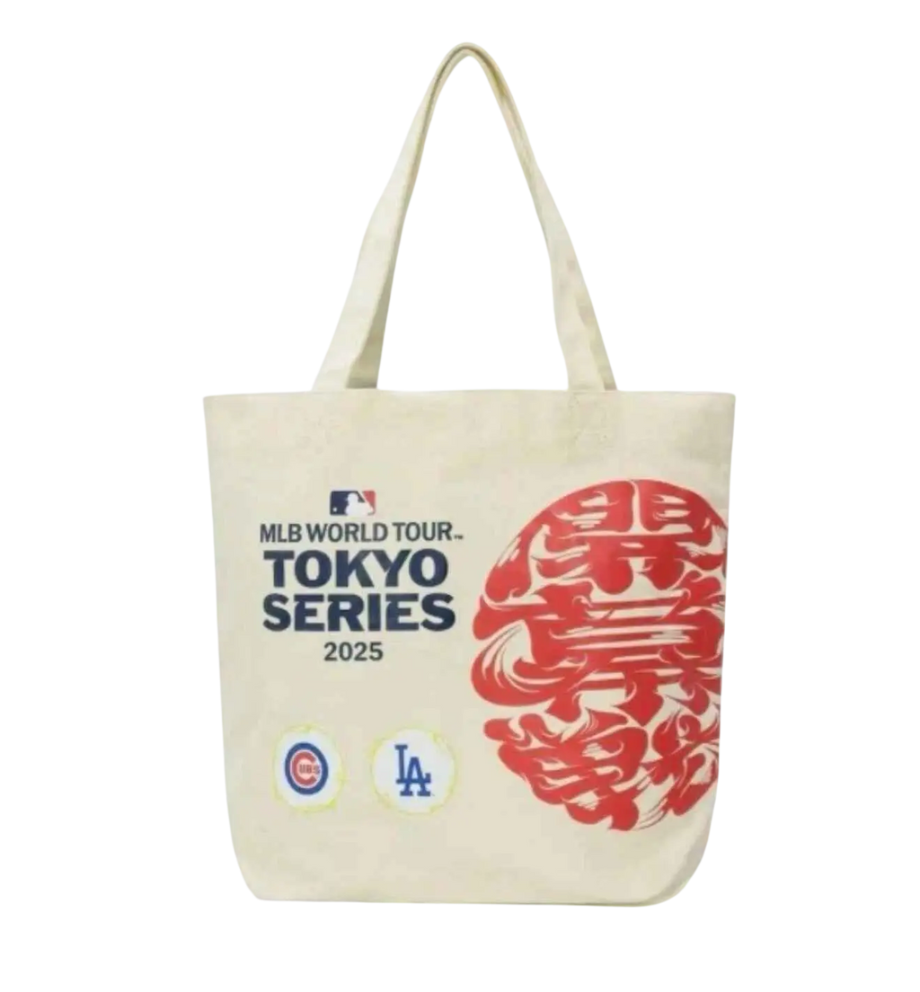 Cream-colored canvas tote bag with bold red and navy graphics for MLB world tour Tokyo Series 2025 featuring Cubs and Dodgers logos
