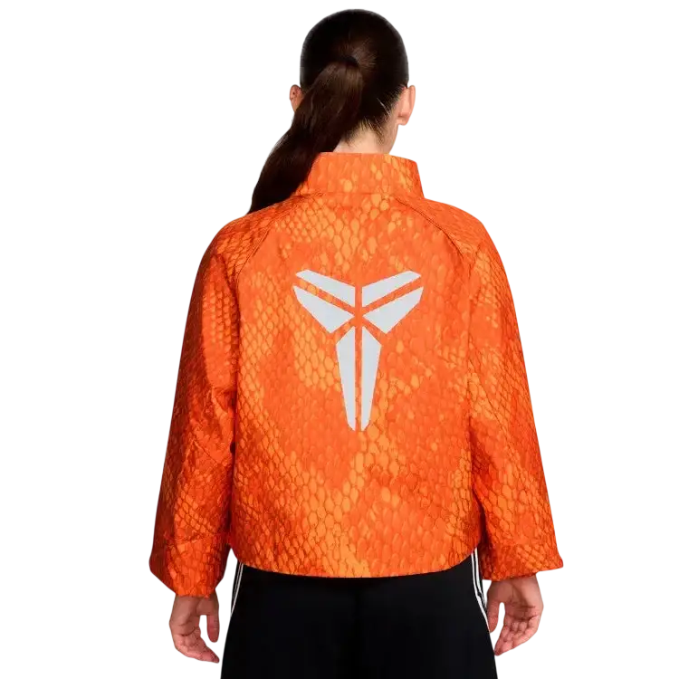Back view of nike kobe womens lightweight woven jacket in safety orange with snakeskin texture and white kobe bryant logo