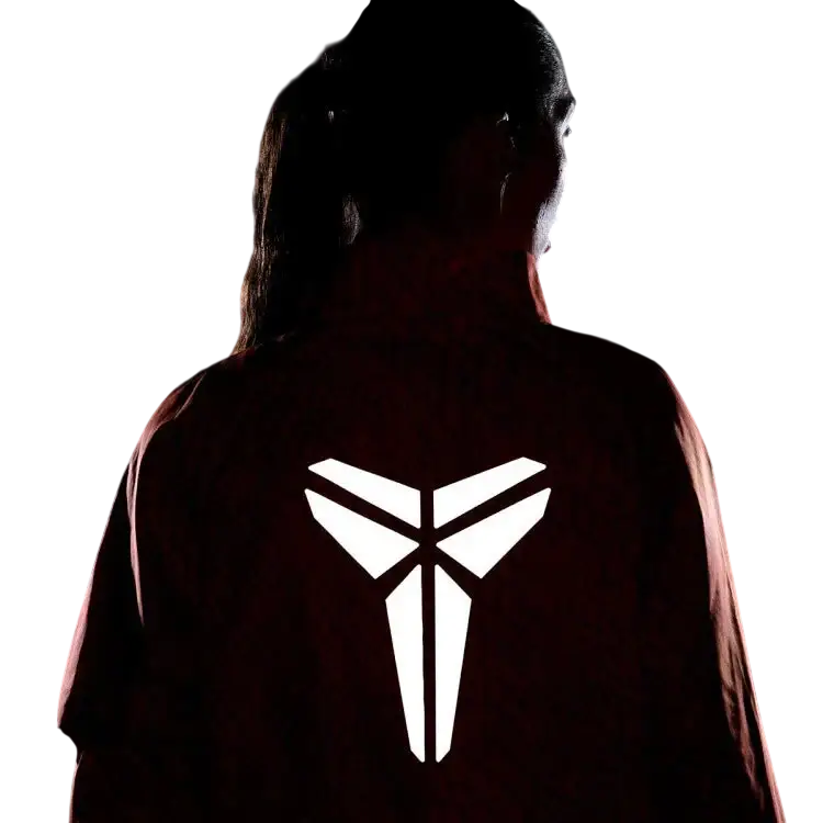 Back view of nike kobe womens lightweight woven jacket in safety orange with a white kobe bryant logo on dark red fabric