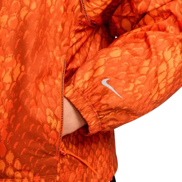 Orange nike kobe women’s lightweight woven jacket with snakeskin pattern and white swoosh logo on the sleeve