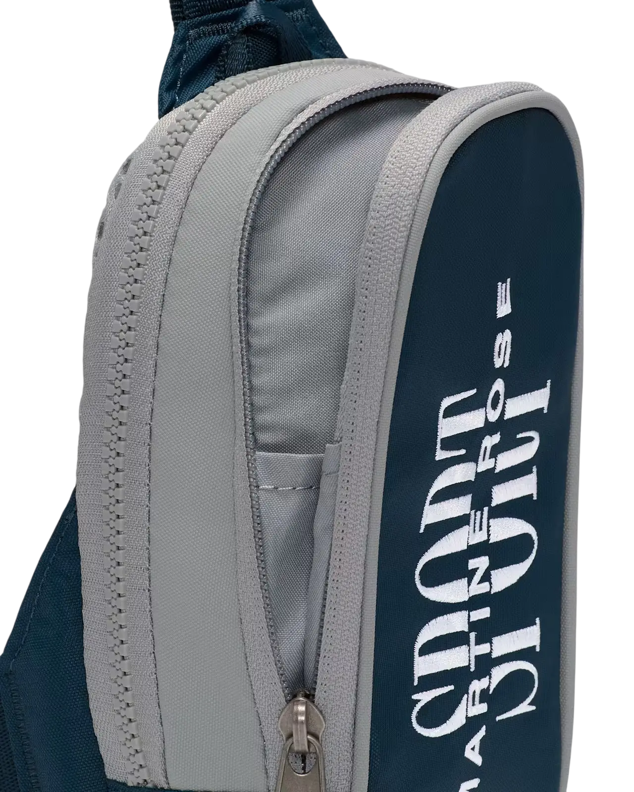 Navy blue and gray nike x martine rose crossbody bag with white branding on sport backpack side panel