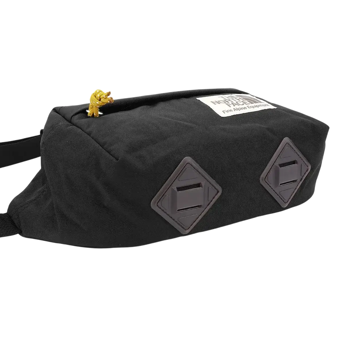 North face berkley lumbar bag in black and mineral gold with diamond gray patches and gold lion charm on top