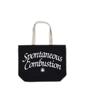 Black canvas tote bag with white handles featuring spontaneous combustion in stylized script by Online Ceramics