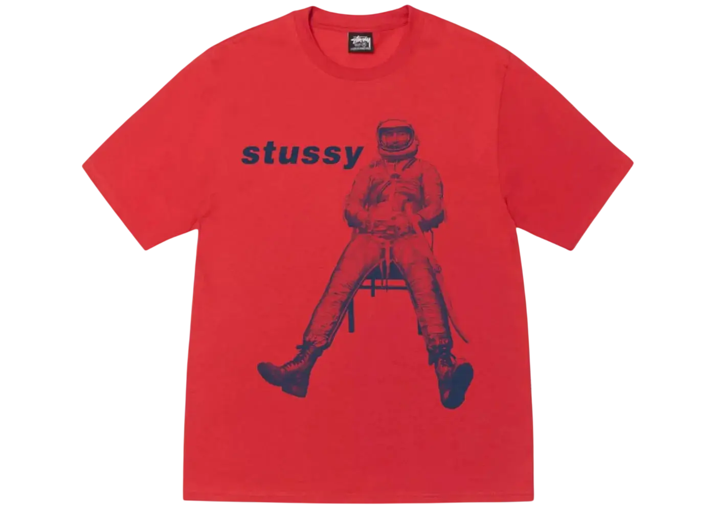 A vibrant red Stussy astronaut tee with a bold blue graphic of an astronaut seated on a chair