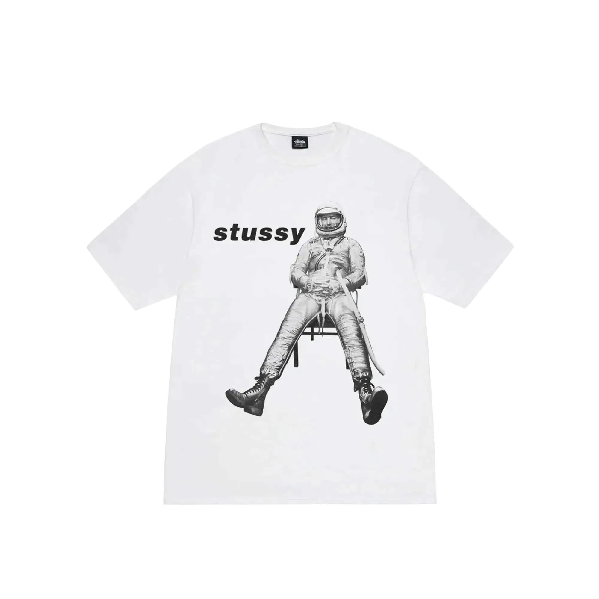 White Stussy astronaut tee featuring a black and white graphic of an astronaut seated on a chair on the front