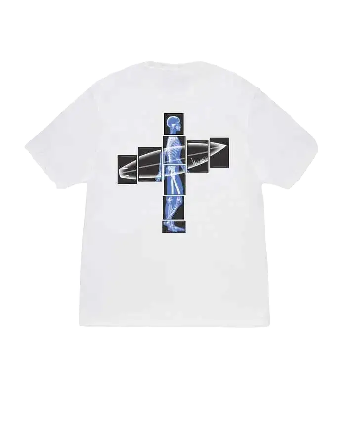 White short-sleeved Stussy body scan tee featuring a cross-shaped graphic of black-framed x-ray skeleton holding surfboard