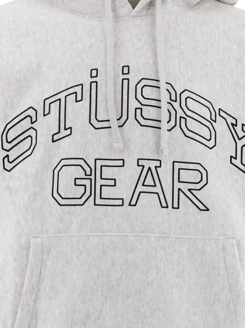 A heather gray stussy gear hoodie with bold black outlined lettering across the chest.