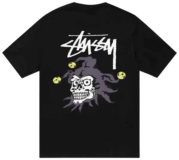Black Stussy Joker tee featuring a white skull graphic with purple smoke and yellow tennis balls on the front