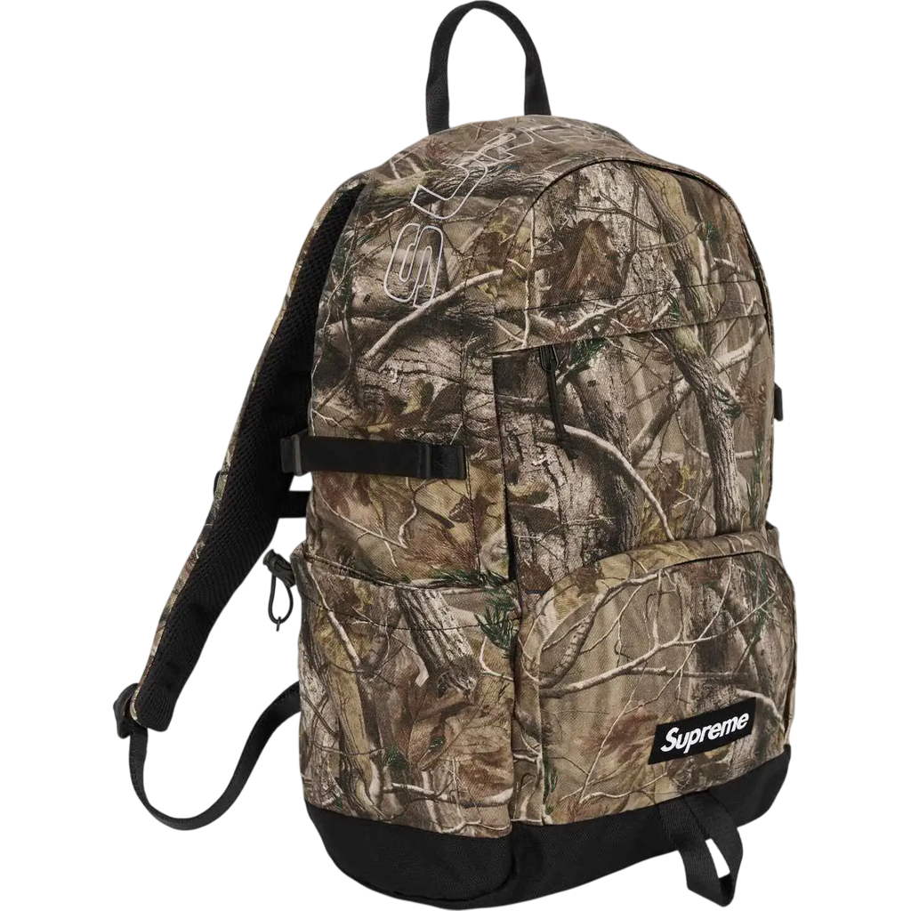 Supreme denim backpack camo fw25 with camouflage pattern black straps and base shown from the back side