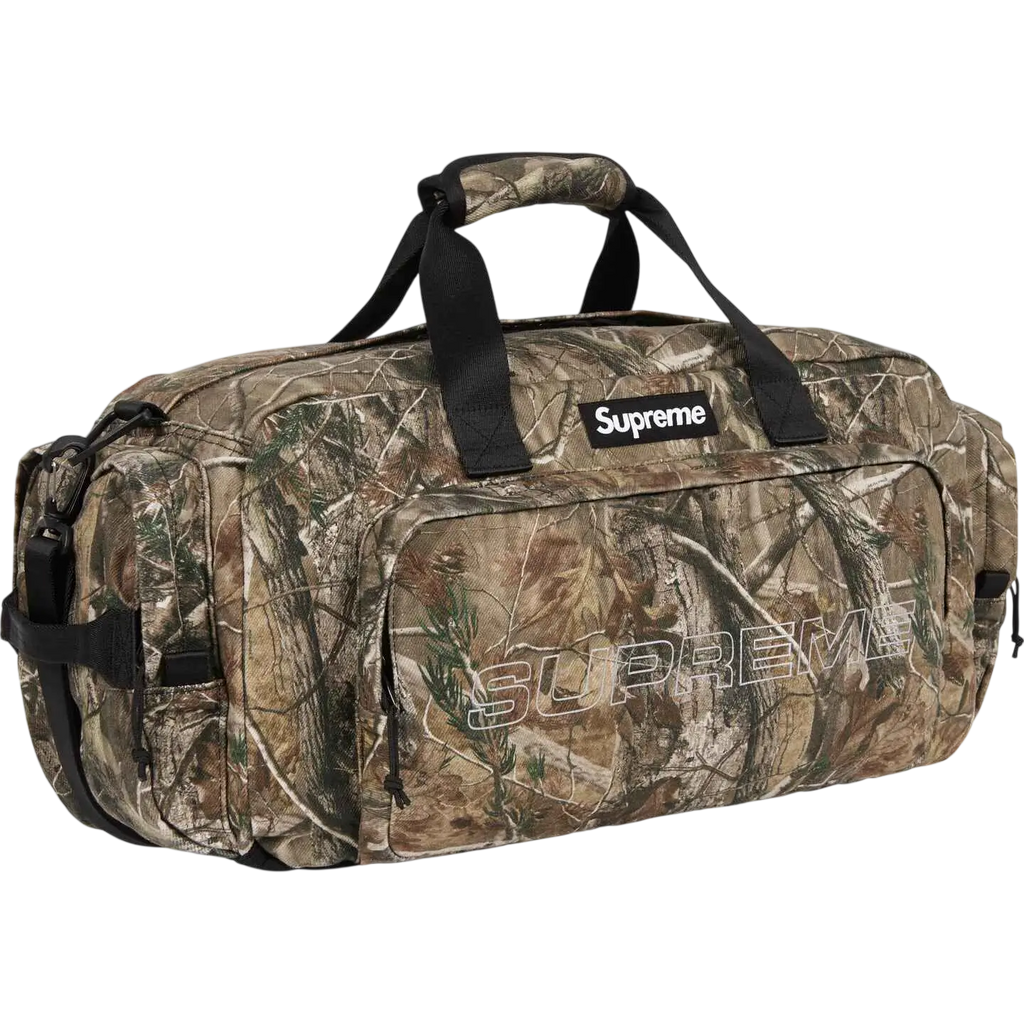 Supreme denim duffle camo with camouflage pattern black handles and prominent white logo fw25 collection bag