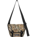 Supreme denim messenger bag camo FW25 with camouflage pattern, black straps, and white logo patch