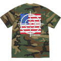 Back of a camouflage-patterned supreme target t-shirt with white target design over american flag in woodland camo colors