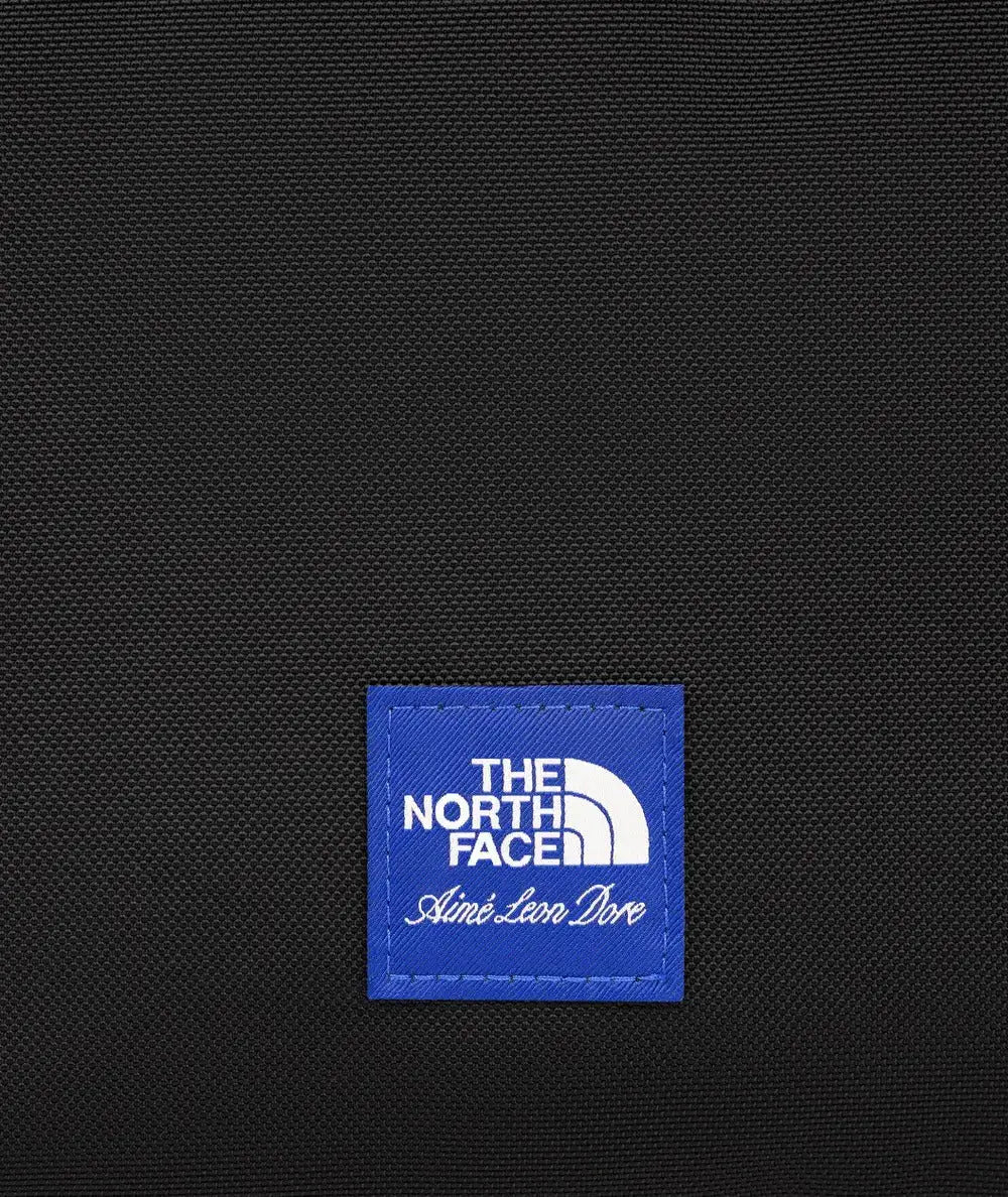 The north face x aime leon dore black textured fabric shoulder bag with blue embroidered logo patch