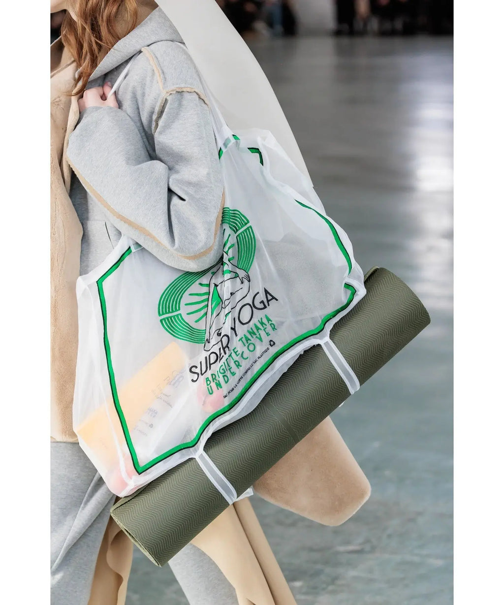 Undercover women’s transparent tote yoga bag white with green trim and sudah yoga logo carrying olive-green mat
