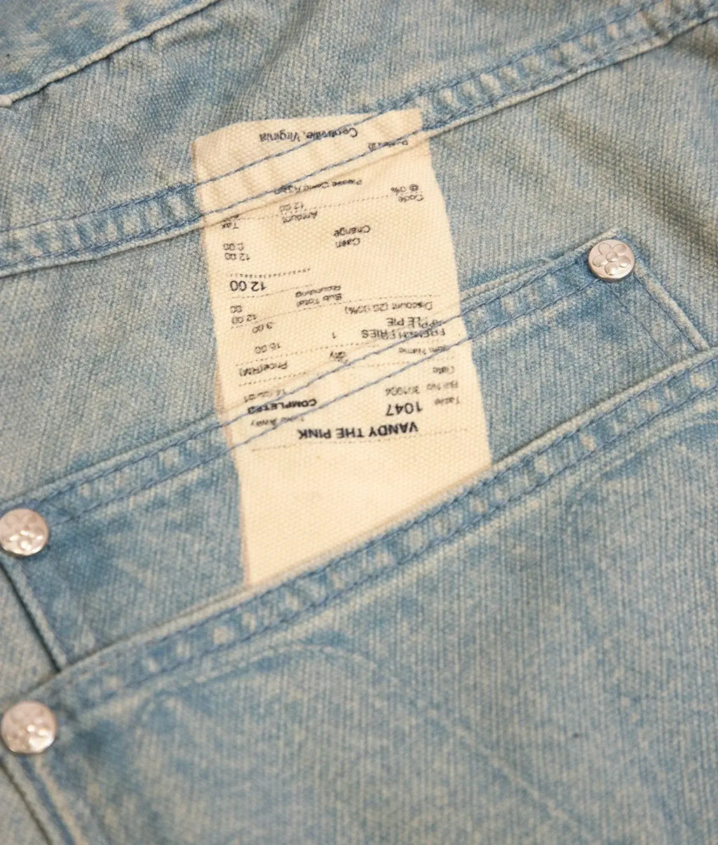 A light blue denim jacket with stitched details and a white label reading vandy the pink from vandy the pink fries trompe loeil denim