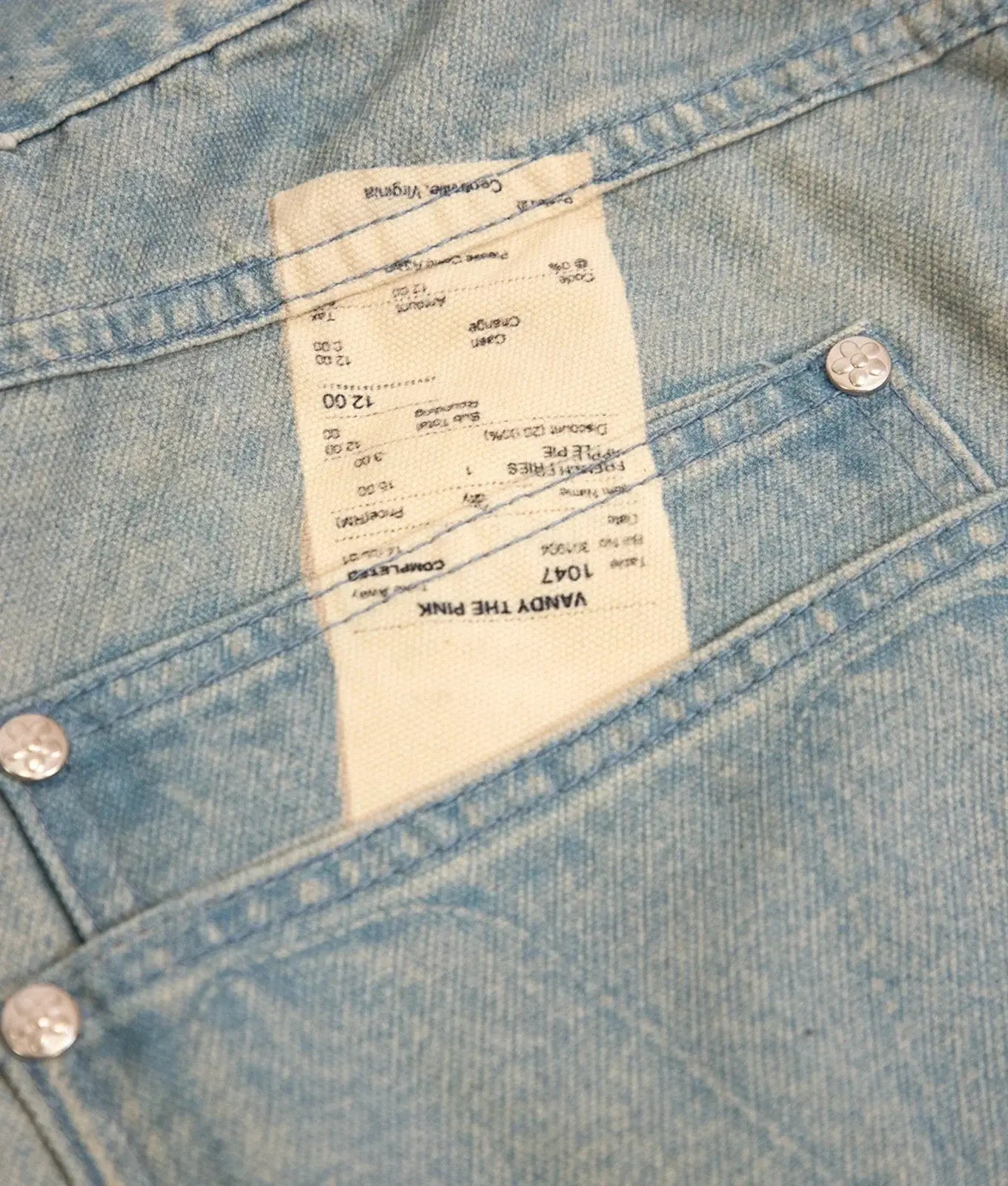 A light blue denim jacket with stitched details and a white label reading vandy the pink from vandy the pink fries trompe loeil denim