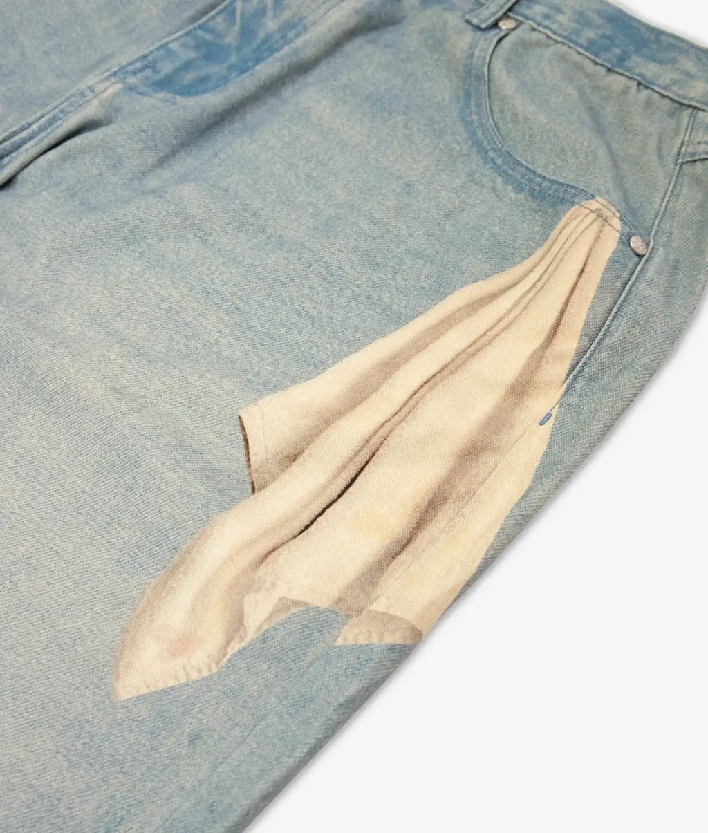 Light-wash denim jeans vandy the pink fries trompe loeil denim with a beige fabric patch over the front pocket