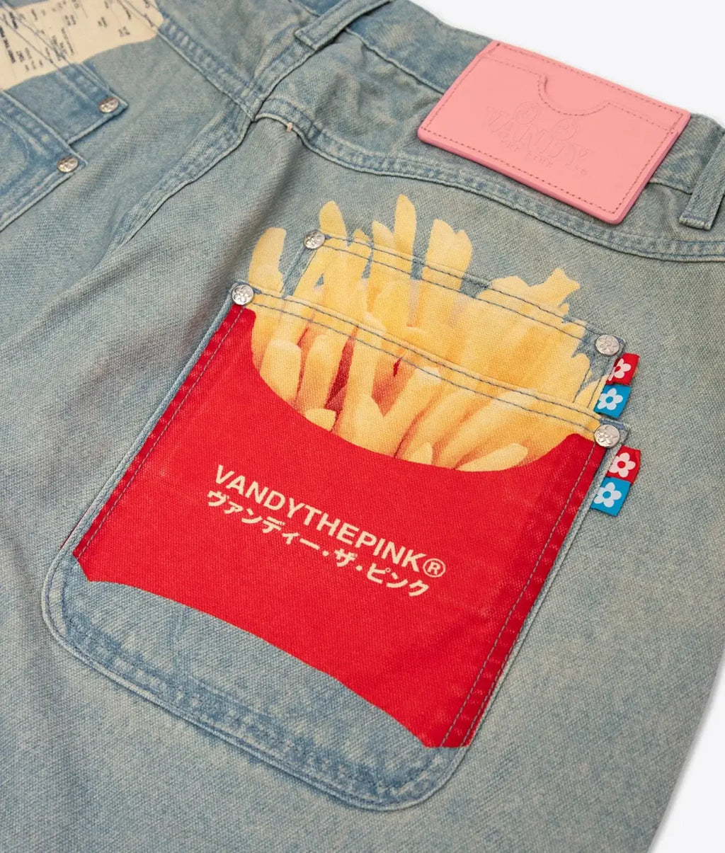 A red pocket with golden french fries print and vandythepink embroidery on denim pants in vandy the pink fries trompe loeil denim