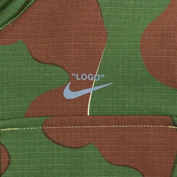 Women’s nike x off white nrg jacket aop 2 camo with light blue nike swoosh embroidered on green brown camouflage fabric