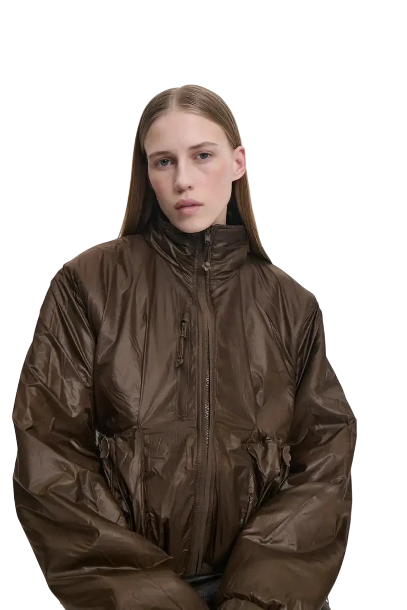 A shiny brown puffer jacket with high collar and front zipper from The North Face x Cecile Bahnsen fleece collection
